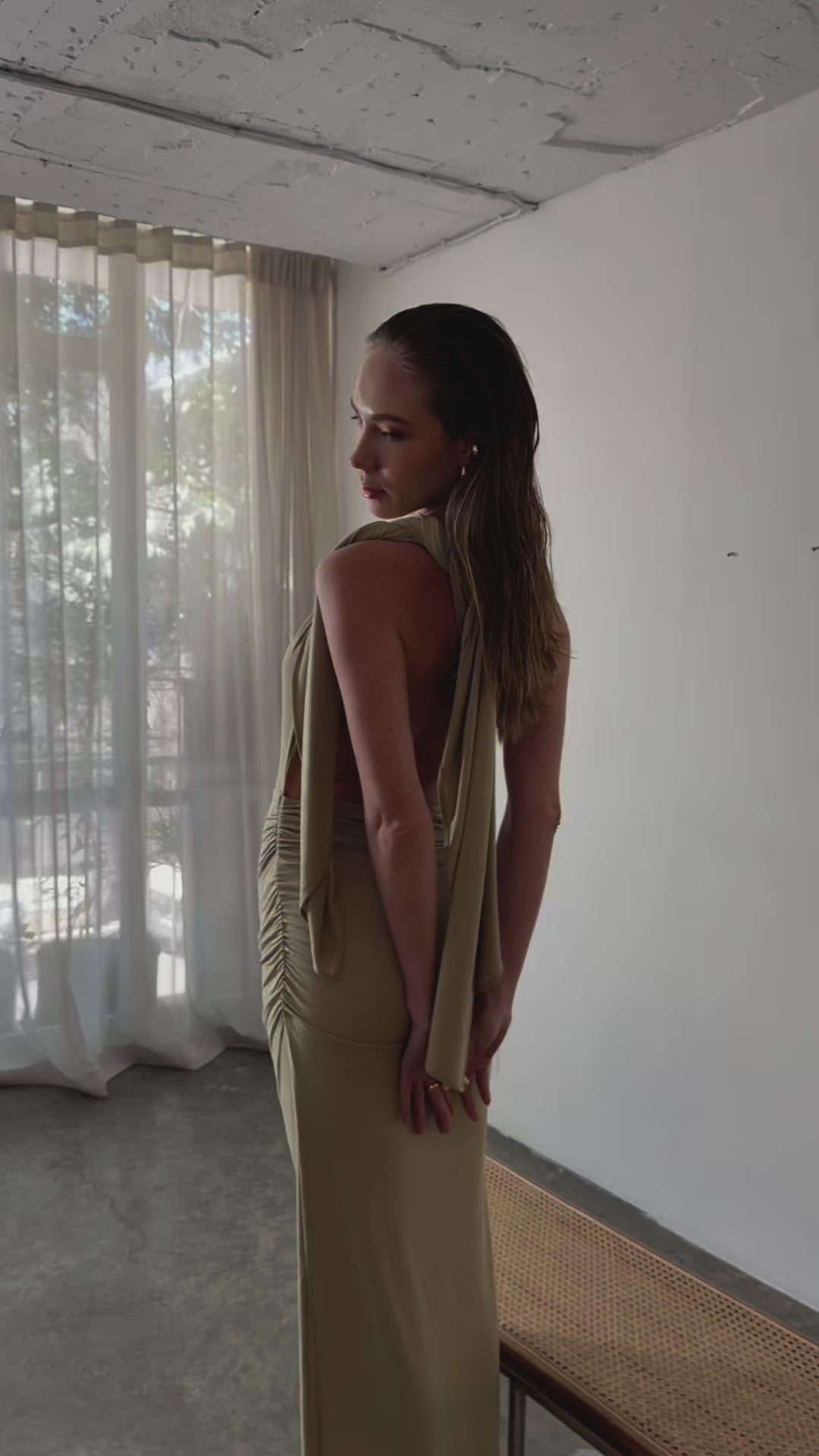 Female model posing in one shoulder maxi dress for resort wear
